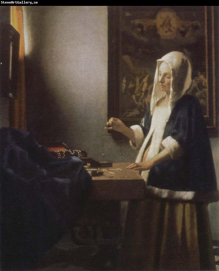 Jan Vermeer woman holding a balance